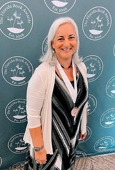 Tara Lynn Masih at the Florida Book Awards banquet in Tallahassee wearing her medal 2023