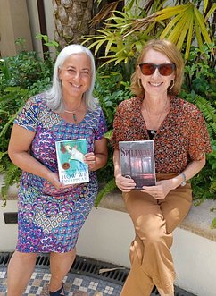 Tara Lynn Masih and Kim Bradley showing their winning Florida Book Award covers 2023
